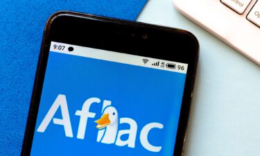 In this photo illustration an Aflac logo is seen displayed on a smartphone.