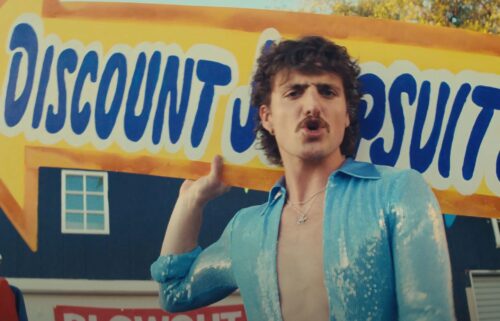 Benson Boone is seen in his "Mr. Electric Blue" music video.