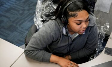 A hotline provider works at her station at the 988 call center on July 30