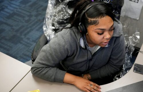 A hotline provider works at her station at the 988 call center on July 30