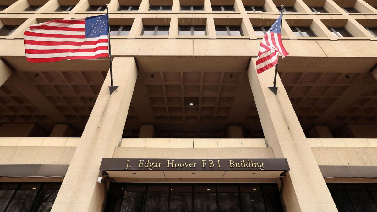 <i>Kevin Lamarque/Reuters via CNN Newsource</i><br/>Flags fly over an entrance to FBI headquarters.