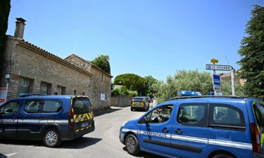 French law enforcement vehicles form a perimeter around the site of the shooting in the village of Goult.