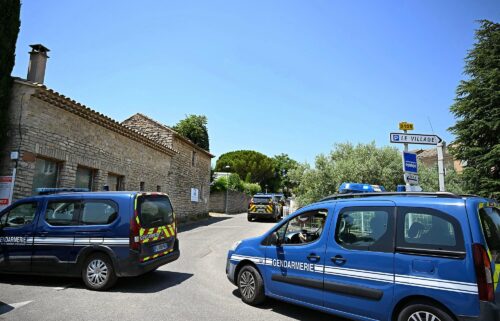 French law enforcement vehicles form a perimeter around the site of the shooting in the village of Goult.
