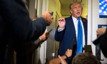 President Donald Trump speaks with reporters while flying aboard Air Force One en route from Calgary