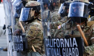 National Guard troops wear gas masks during protests against federal immigration sweeps