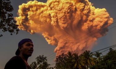 A villager watches the eruption of Mount Lewotobi Laki-Laki as seen from Talibura village in Sikka