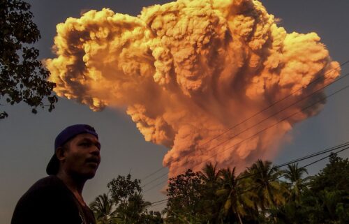 A villager watches the eruption of Mount Lewotobi Laki-Laki as seen from Talibura village in Sikka