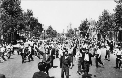 Pro-monarchy rioters take to the streets of Tehran in August 1953.
