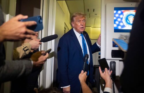 President Donald Trump speaks with reporters while flying aboard Air Force One en route from Calgary