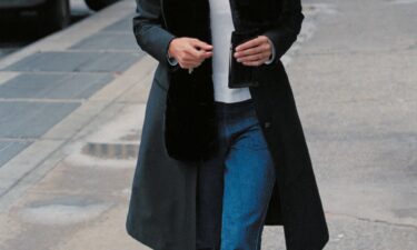 A tortoise shell headband and kick-flare jeans are among the key elements of Bessette-Kennedy's signature look.
