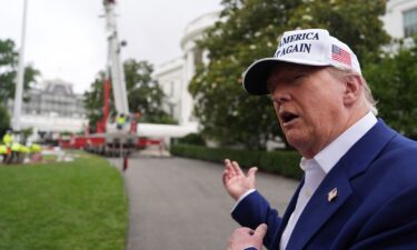 President Donald Trump speaks as a flagpole is installed on the South Lawn of the White House on June 18