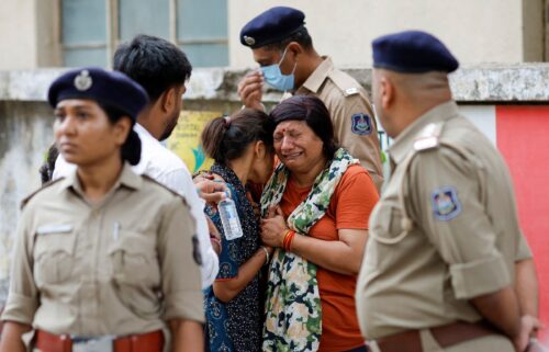 Relatives of victims mourn as they wait outside the postmortem room at a hospital