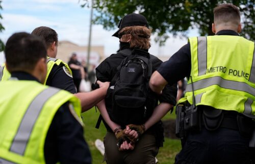 Elijah Millar is arrested by Metro Nashville Police Department officers after he allegedly brandished a gun and harassed demonstrators during a "No Kings" protest in Nashville on June 14.