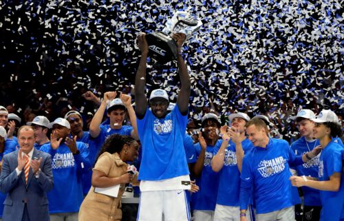 Duke Blue Devils center Khaman Maluach raises the trophy and celebrates with teammates after winning the 2025 ACC Conference Championship.