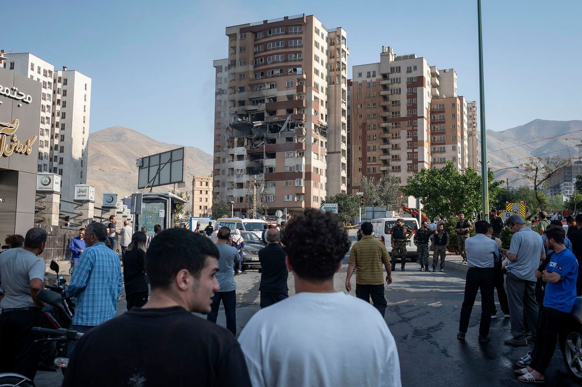 <i>Morteza Nikoubazl/NurPhoto/Getty Images via CNN Newsource</i><br/>Iranian people gather at the scene of an explosion at a residential complex due to Israeli attacks in Tehran