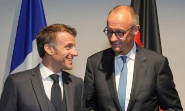 French President Emmanuel Macron speaks with Germany's Chancellor Friedrich Merz before a meeting on the sidelines of the NATO summit in The Hague