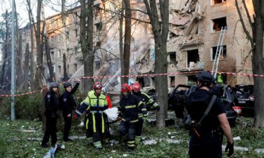 Emergency Service personnel carry a body following Russian strikes on Kyiv on June 23.