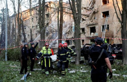 Emergency Service personnel carry a body following Russian strikes on Kyiv on June 23.