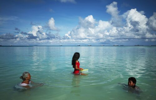 People swim in the lagoon in Funafuti