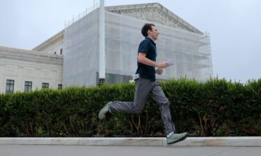 CNN's Max Rego runs out of the US Supreme Court building carrying an ruling during the last day of the court's term on June 27