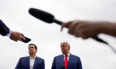 President Donald Trump stands next to Secretary of State Marco Rubio at Morristown Municipal Airport in Morristown