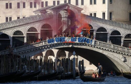 Demonstrators on the Rialto Bridge stand by a banner that reads 'No space for Bezos' in Venice on Saturday.