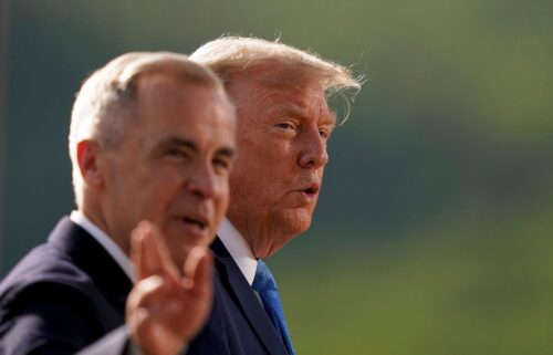 Canadian Prime Minister Mark Carney and US President Donald Trump arrive for a family photo during the G7 Summit in Alberta