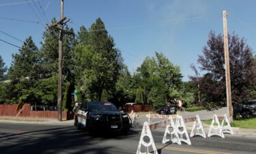 Kootenai County Sheriff’s deputies block a road leading to an area where multiple firefighters were attacked.