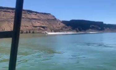 Scooper frefighting plane draws water from Lake Billy Chinook