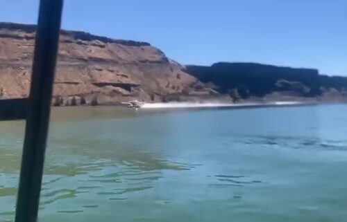 Scooper frefighting plane draws water from Lake Billy Chinook