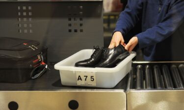 An air traveler places his shoes in a bin before passing through a TSA checkpoint at Los Angeles International Airport in 2014.