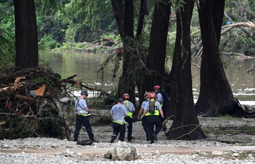 Members of a search and rescue team look for people near Camp Mystic in Hunt