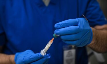 A health worker prepares a dose of the measles vaccine in Lubbock