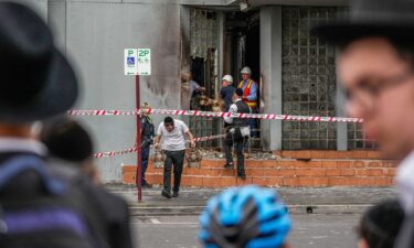 Members of the synagogue recover items from the Adass Israel Synagogue on December 6