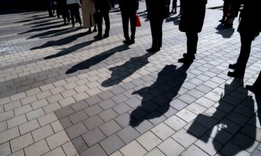 Job seekers wait in line to enter a job fair event in Silver Spring