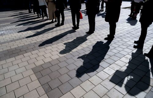 Job seekers wait in line to enter a job fair event in Silver Spring