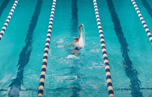 Adding more resistance — such as swimming against the water — can ramp up a workout.