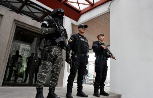 Security forces stand outside the National Court of Justice following a hearing for the extradition of Ecuadorean gang leader Jose Adolfo Macías