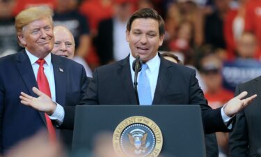 President Donald Trump looks on as Florida Governor Ron DeSantis speaks during the Florida Homecoming rally at the BB&T Center in 2019.