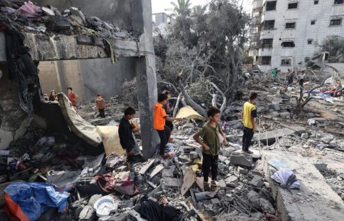 Palestinian children check the rubble of a residential house in Deir el-Balah in the central Gaza Strip on July 1
