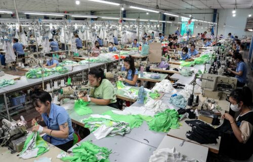 Vietnamese garment factory workers stitch apparel at a factory in Ho Chi Minh City.