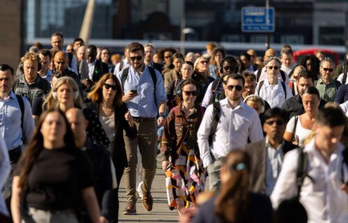 Commuters cross London Bridge in London on Wednesday