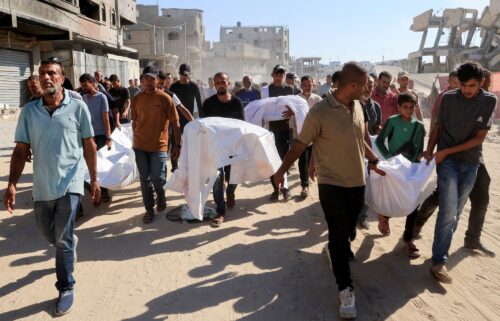Mourners carry the bodies of Palestinians who were killed in an overnight Israeli strike
