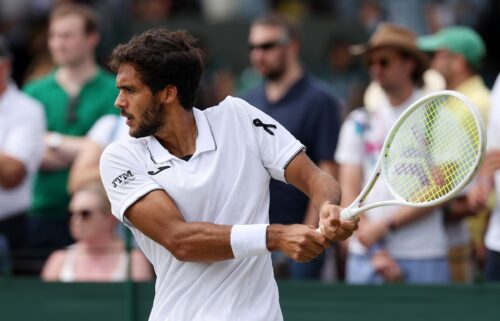 A black ribbon is worn by Francisco Cabral of Portugal as he plays his men's doubles second-round match on Friday at Wimbledon.