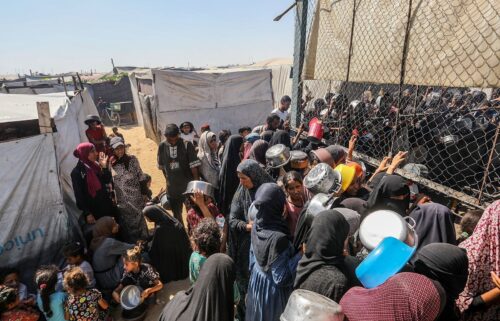 Palestinians gather to receive food on July 3