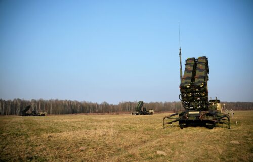 US soldiers walk next to a Patriot missile defense battery during joint exercises at the military grounds in Sochaczew