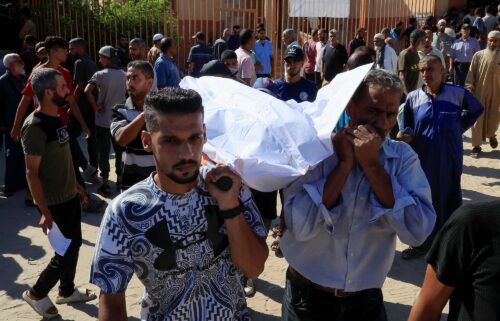 People carry a body as they mourn Palestinians who were killed in an incident on July 16 while seeking aid in Khan Younis in the southern Gaza Strip on July 16.