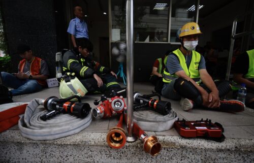 Rescuers and volunteers take shelter during an air raid drill as part of the annual Han Kuang military exercises