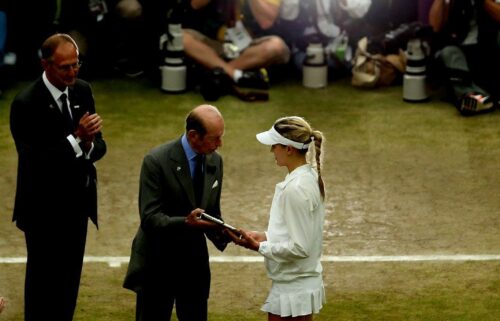 Bouchard receives the Wimbledon runners-up trophy after losing the 2014 final against Petra Kvitová.