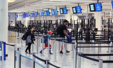 A family rushes to a TSA screening checkpoint at Orlando International Airport. The Department of Homeland Security announced an expansion of Transportation Security Administration checkpoints for families traveling with children and military members on July 17.